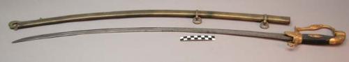 Sheath with curved sword. Sheath is gold-colored