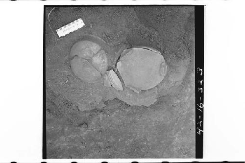 Burial as found, showing two inverted pottery vessels covering bones.