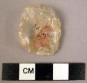 Small, oval quartz flake with signs of use on the edges