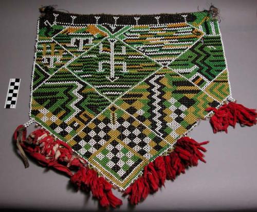 Skirt of glass beads strung on fibre, red and white cotton cloth fringe