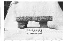 Carved tripodal stone metate