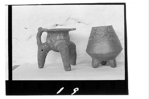 a. Brown - orange tripod jar of Chibcha style. Handle on one side. Hollow legs