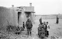 Woman with group of children outside of building