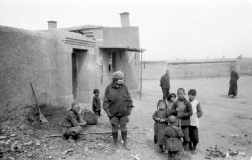 Woman with group of children outside of building