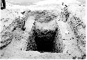 People looking into excavation pit; Marked " Cerro de Trinidad. Looking South a