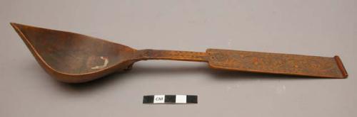 Wooden spoon with pointed bowl and floral designs on handle