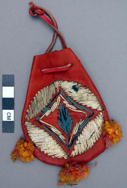 Pouch, leather, drawstring opening, embroidered gold thread, tassels at base