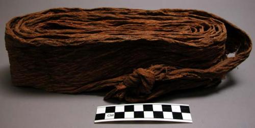 Woman's carrying strap--dark brown material made by a tapa-like process