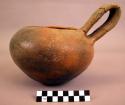 Restored pottery vessel with strap handle