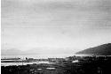 Buildings on lake shore with distant mountains