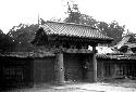 Wall and gate with ornate roof