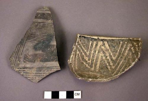 Black on white potsherds. One rim, one body. rim sherd with interior paint onl