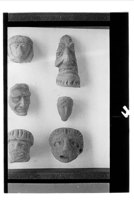 Six pottery heads   a,e,f: brown   b,c: fine orange   d: red