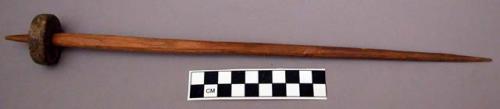 Wooden spindle with flat stone whorl