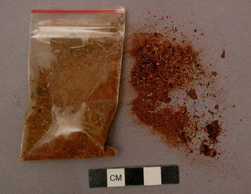 Packets containing samples of red dye, soda and black stone for drying cloth