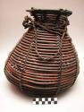 Basket, open coiled, lashed with plant fiber, tapered body, flared rim