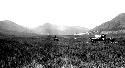 People on horseback and wagon moving through field