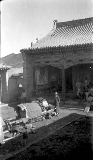 Janet Wulsin in courtyard of temple(?) with supplies