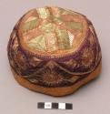 Cloth hat with designs in gold and purple thread