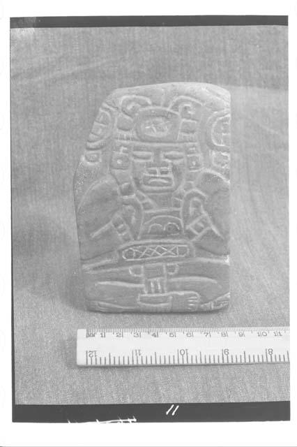 Jade plaque with seated figure, full face