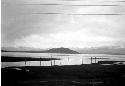 Pilings off lake shore, distant mountains