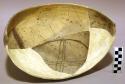 Ceramic partial bowl, brown on yellow interior, reconstructed