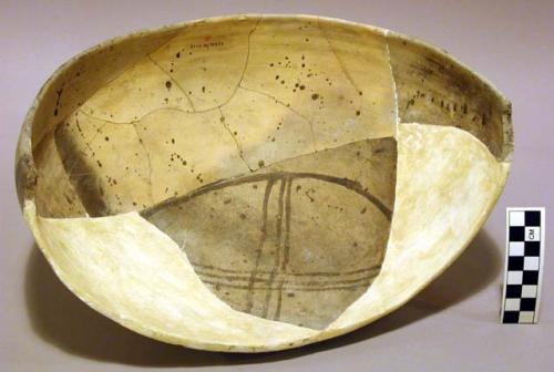 Ceramic partial bowl, brown on yellow interior, reconstructed