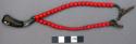 Man's bead necklace - reddish-coral in color, with small buffalo horn ornament