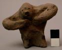 Figurine, ceramic, squatting or seated figure, hands on chest, arms out