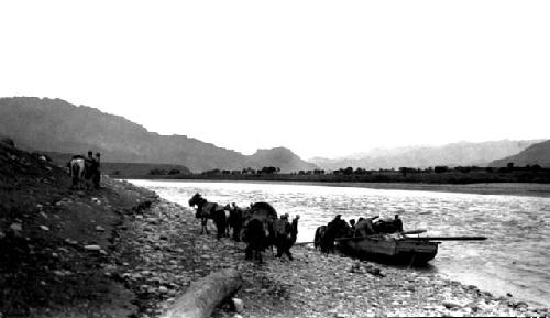 Boat moored at river edge, people and horses on shore