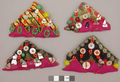 Three-cornered pillow-like ornaments covered with beads & shells