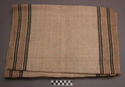 Woven textile, brown and tan banded borders on natural