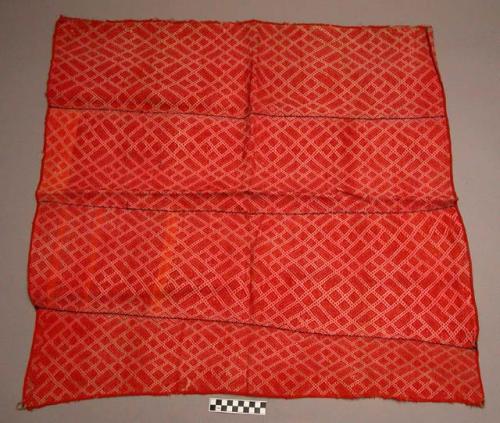 Textile shoulder cape with designs in red brocade