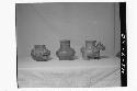 Three plumbate vessels, left- Old man effigy jar (see 43-9-21)
