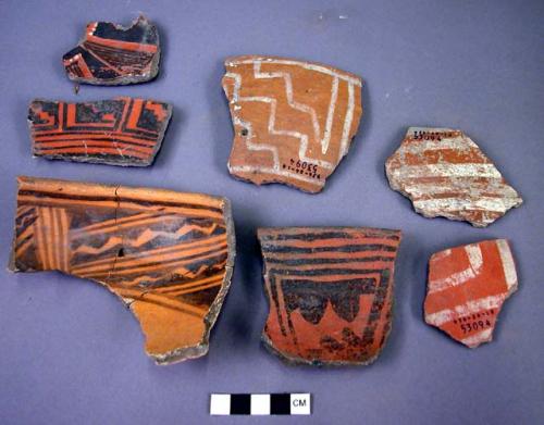 Sherds, black on white decorated on one side, red on white on the other. 11 rim