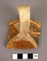 Fragment of black on yellow pottery cup--elongated strap handle