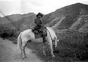 Janet Wulsin on horseback in mountains