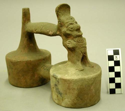 Ceramic whistle bottle, double lobed, figure on one side, exfoliating