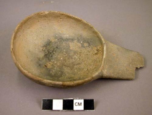 Ceramic ladle, undecorated grey ware, flat broken handle