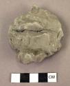 Fragment of a clay face, unfired, depicting mouth and lower nose