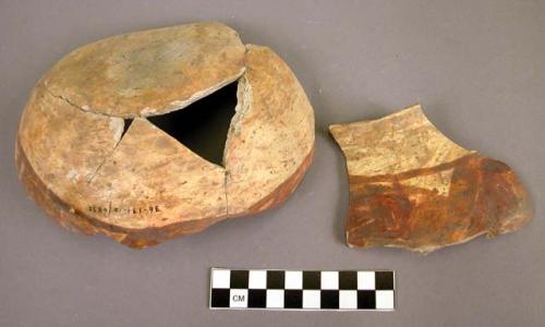 Fragments of black on yellow pottery jar