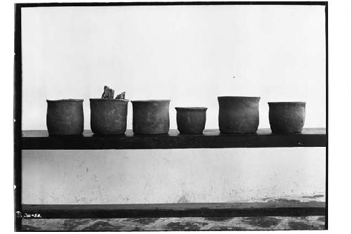 Six flower pots, part of ceremonial offering under Stela N