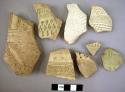 8 potsherds - buff incised