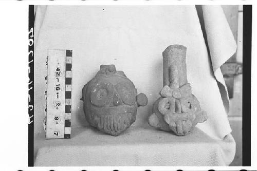 2 fragmentary Tlaloc bottles. Red clay. Faces of white paint on figure to right.