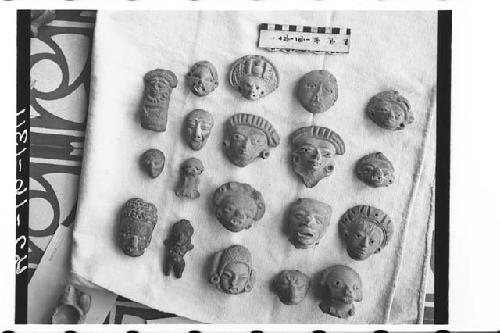 18 pottery figurine fragments, mainly heads.