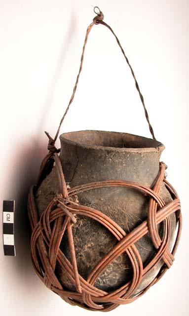 Pottery vessel with bamboo carrying sling