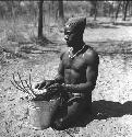 Bela playing a //guashi on a tin bucket