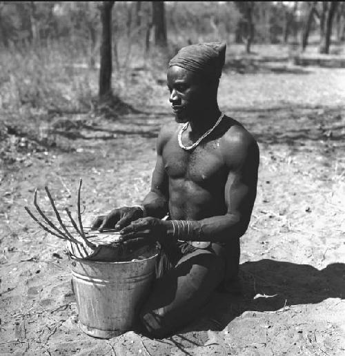 Bela playing a //guashi on a tin bucket