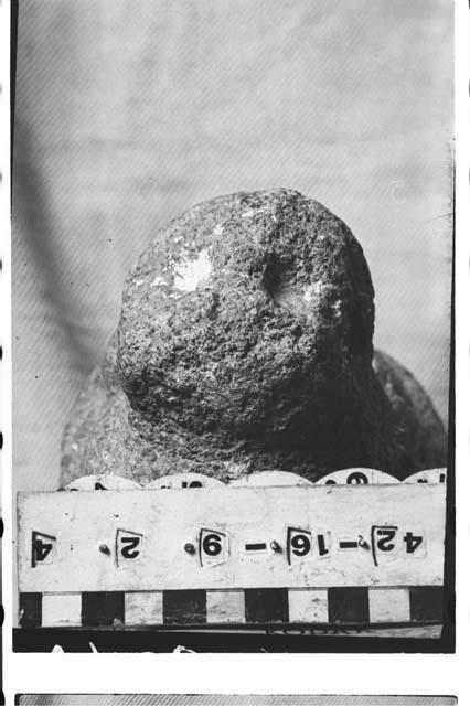 Crude effigy stone figure of gray granitic stone, resembling a death sculpture