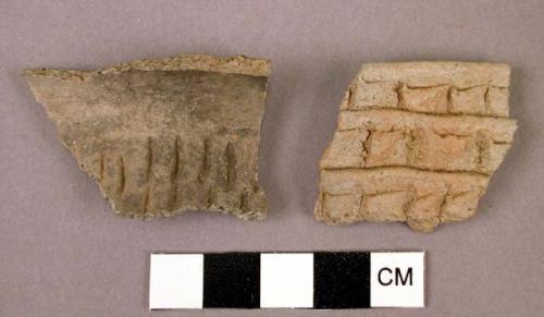 Ceramic rim and body sherd, grey ware, 1 impressed, 1 with applique design